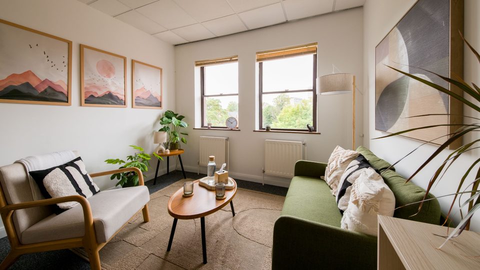 The Birmingham consulting room with comfortable seating, plants and natural light.
