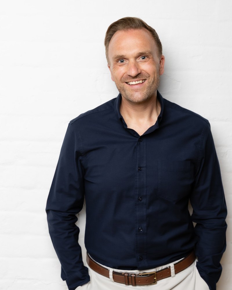 Rob Higgins smiling against a light background.